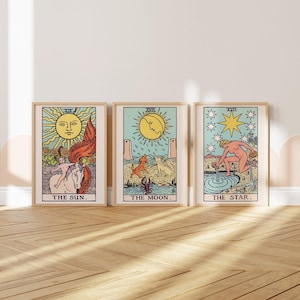May include: Three rectangular wall art prints featuring tarot card illustrations. The left print shows The Sun with a child on a horse, the center shows The Moon with a dog and wolf, and the right shows The Star with a figure pouring water.