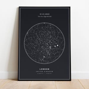 May include: A black rectangular poster featuring a white circular star map. Text at the top reads 01.01.2023 and 'The First Night We Met'. Text at the bottom reads LONDON, UNITED KINGDOM, and the coordinates 51.5072 N | 0.1276 W.