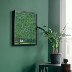 a green room with a potted plant and a painting on the wall
