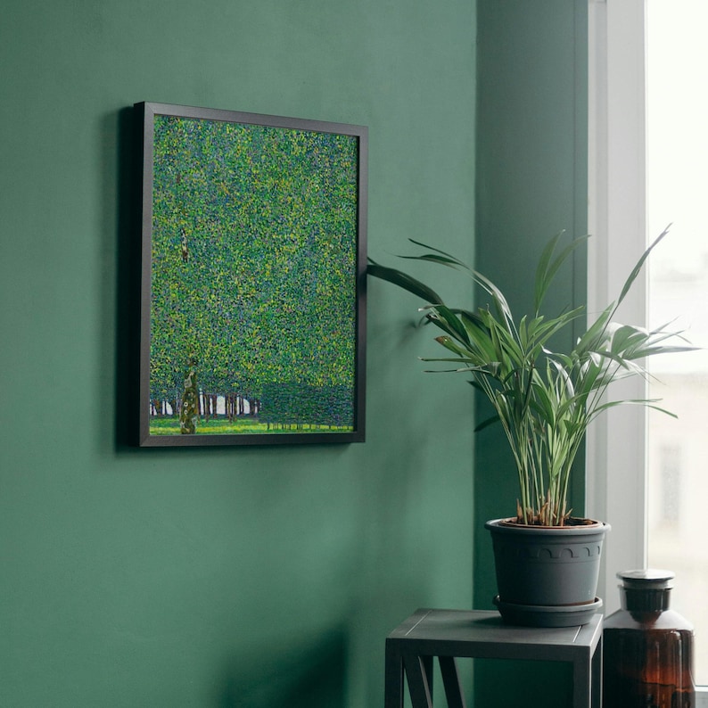a green room with a potted plant and a painting on the wall