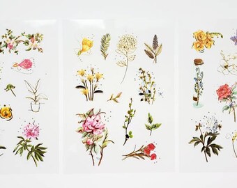 May include: A sheet of floral stickers featuring a variety of flowers, including lilies, roses, and daisies. The stickers are printed on clear, transparent paper and are perfect for adding a touch of whimsy to journals, planners, and other craft projects.