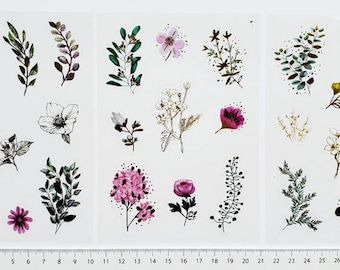 May include: A sheet of floral stickers with a variety of flowers and leaves in shades of green, pink, white, and brown. The stickers are perfect for adding a touch of nature to your crafts, journals, and planners.