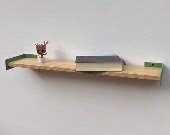 May include: A wooden floating shelf with light green metal brackets. A small Groot figurine in a white pot and a closed book rest on the shelf. The shelf is mounted on a white wall.