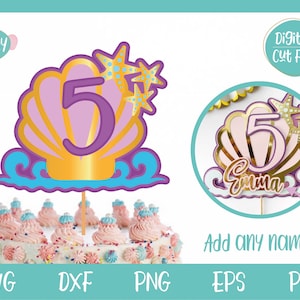 May include: A digital cut file for a mermaid-themed cake topper. The topper features a purple number 5 inside a gold seashell with pink and purple accents. Two gold starfish with blue centres are on top of the seashell. The topper is on a cake with pink and white frosting and sprinkles.