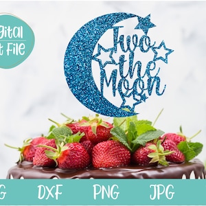May include: Blue glitter crescent moon cake topper with the text "Two the Moon" and stars.