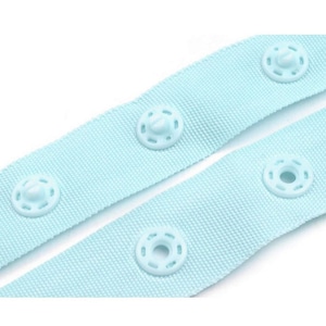 May include: Light blue fabric with plastic snap buttons. The fabric is woven and has a subtle texture. The buttons are round and have a raised centre.