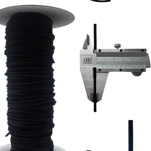 May include: A spool of black elastic cord, measuring 1/8 inch in diameter, with the text "ELASTICORD" and "BLACK TL 1421E" printed on a white background.