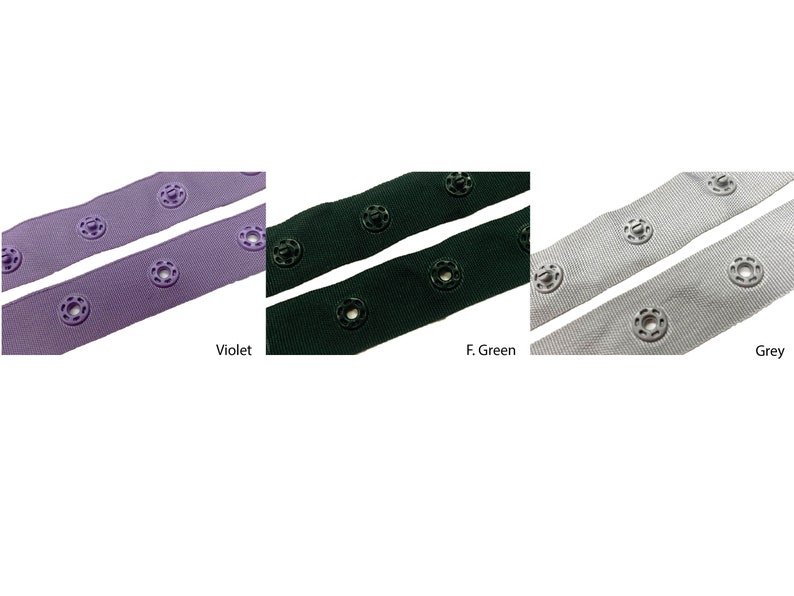 May include: Three strips of fabric with buttonholes and buttons. The fabric is in three colors: violet, forest green, and gray.
