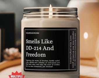 May include: A white candle with a black label that reads "Smells Like DD-214 And Freedom". The candle is on a wooden tray. The label also says "Handcrafted with love 100% premium soy wax candle 50-60 hours burning time".