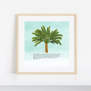 May include: Framed art print depicting a palm tree illustration with green fronds and a brown trunk, set against a light blue backdrop. The artwork includes text from Psalm 92:12-14, presented within a wooden frame.