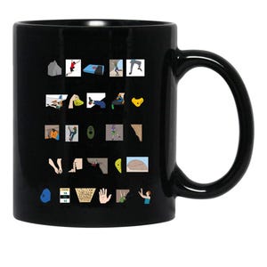 May include: A black ceramic mug featuring a multi-colored graphic alphabet design related to rock climbing. The print displays various climbing icons, equipment, and actions arranged in a grid, with each letter corresponding to a specific term.