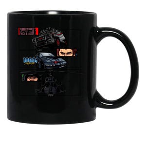 May include: Black ceramic mug featuring a graphic of vehicles and eyes, including a black car, a helicopter, and a truck. The text "1980s" is also visible on the mug. The mug has a large handle for easy gripping.