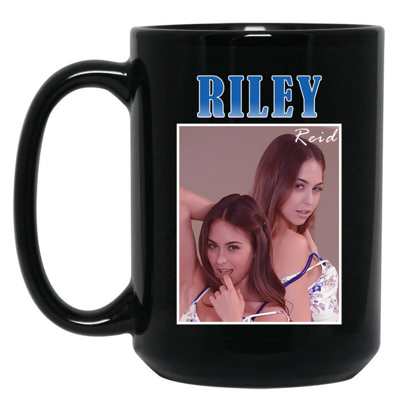 May include: Black ceramic mug with a large handle. The mug features the name "RILEY" in blue block letters above a photo of a woman. The name "Reid" is printed in white script below the name "RILEY".
