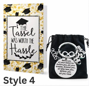 May include: A graduation-themed gift set featuring a greeting card and a keychain. The card has the text "The Tassel Was Worth The Hassle" on a white background with gold accents. The keychain includes a charm with the year "2026" and a message.