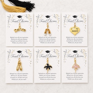 May include: A collection of gold-colored tassel charms on cards. The charms include ballet shoes, the word "dance", and a heart with "I ♡ TO DANCE!". Each card has the text "Tassel Charms" and a graduation cap graphic.