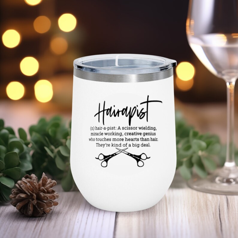 May include: White stainless steel tumbler with a black and white design that reads "Hairapist (n) hair-a-pist: A scissor wielding, miracle working, creative genius who touches more hearts than hair. They're kind of a big deal."