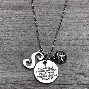 May include: Silver necklace with a charm that says "I can do all things through Christ who strengthens me Phil. 4:13", a baseball charm, and a letter S charm.