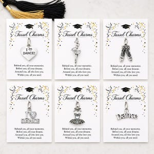 May include: Six silver-toned tassel charms on white cards. Charms include a heart with "I Dance!", a ballerina, ballet shoes, a heart with "I Dance", a tutu, and the word "Dance". Each card has text: "Tassel Charms".