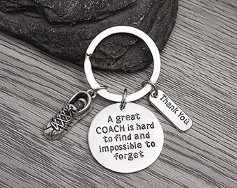 May include: Silver keychain with a running shoe charm and a round tag that reads "A great COACH is hard to find and impossible to forget". A smaller tag attached to the keychain reads "Thank You".