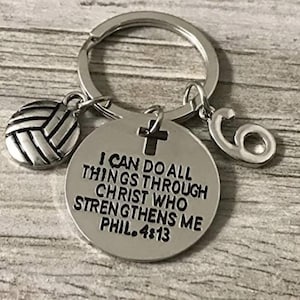 May include: Silver volleyball keychain with a cross charm and a charm with the number 6. The charm with the cross has the text "I can do all things through Christ who strengthens me Phil. 4:13".