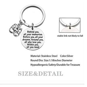 May include: Silver-colored keychain with a round pendant inscribed with a sentimental message. The keychain includes a charm with two theatrical masks. The pendant is 1.18 inches in diameter.
