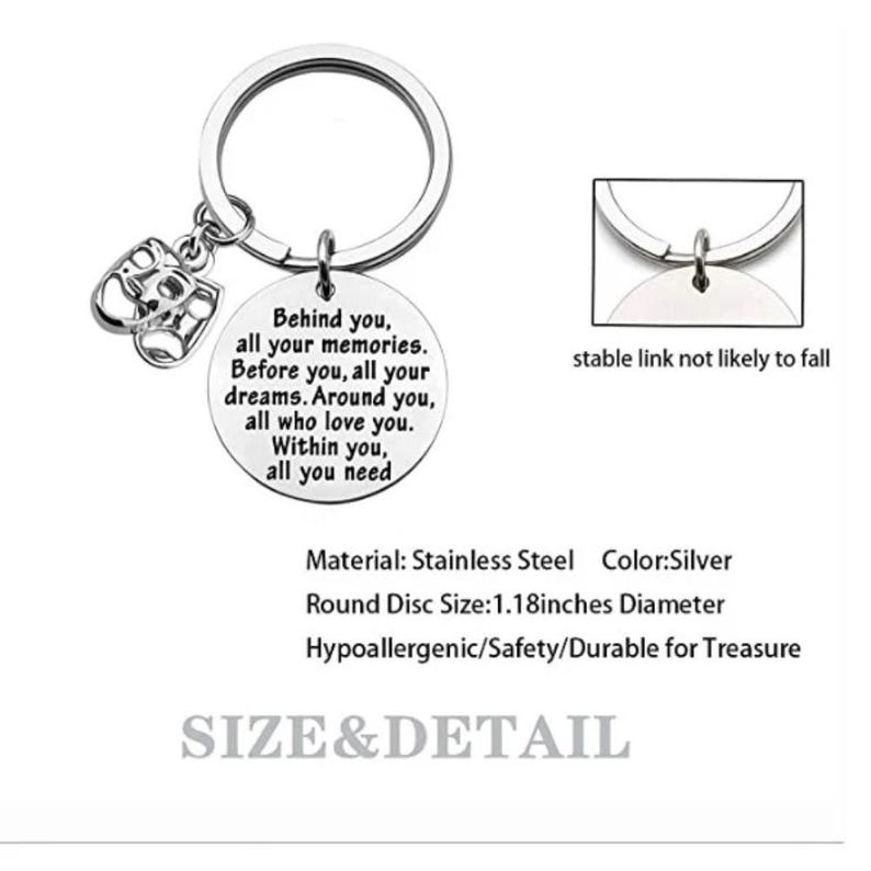 May include: Silver-colored keychain with a round pendant inscribed with a sentimental message. The keychain includes a charm with two theatrical masks. The pendant is 1.18 inches in diameter.