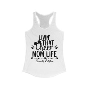 May include: White tank top with a black graphic that says "Livin' That Cheer Mom Life Summit Edition". The graphic includes a Mickey Mouse head.