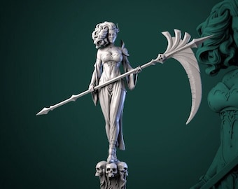 May include: A white painted miniature figurine of a female figure with a double-headed face holding a scythe. The figure is standing on a base with three skulls. The background is a dark green color.