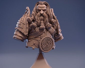 May include: A 3D printed bust of a dwarf warrior wearing armour and a shield with a Celtic knot design. The bust is painted in a light brown colour and is mounted on a square base.