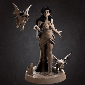 May include: A woman with long dark hair and a flowing gown stands with two small winged creatures. The woman is holding a staff in her right hand and has a confident expression on her face. The creatures are both facing forward with their wings spread out. The scene is set against a dark gray background.