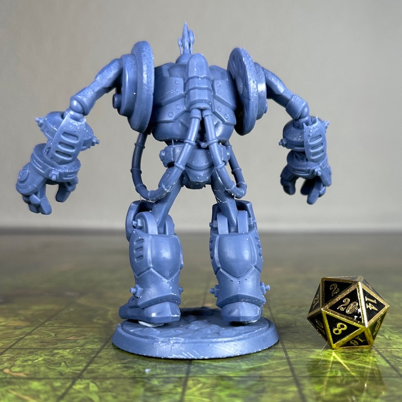 May include: A gray, detailed, plastic miniature of a robot with a steampunk aesthetic. The robot has a large, round head with a single spike on top, and its body is covered in pipes and gears. The robot is standing on a round base.