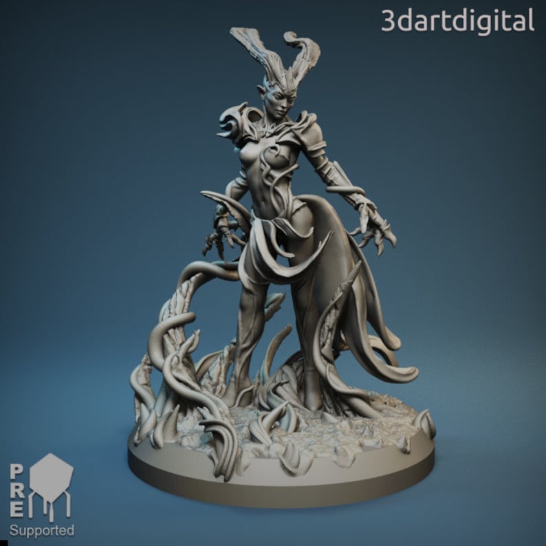 May include: A gray, detailed miniature sculpture of a female figure with antlers, wearing a flowing gown and standing on a base of vines. The figure has a fierce expression and is holding a vine in her hand.
