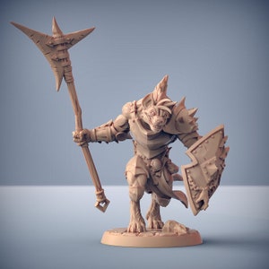 May include: A miniature figurine of a hyena-like creature wearing armor and holding a spear and shield. The figurine is made of a light brown plastic and is painted in a realistic style.