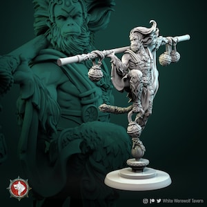 May include: A white painted miniature figurine of a monkey warrior holding a staff with two dangling balls. The monkey is wearing a flowing robe and has a fierce expression. The figurine is standing on a round base.