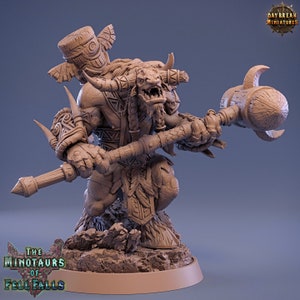 May include: A brown, unpainted miniature figurine of a minotaur warrior holding a large wooden club. The minotaur is wearing a loincloth and has a bull's head with horns. The figurine is standing on a rocky base. The text "The Minotaurs of Fell Falls" is printed on the base.