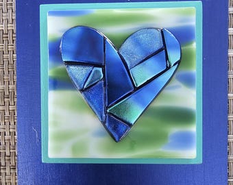 Blue green Glass heart  with fused dichroic glass heart on blue and green glass and  blue  frame  wall art  by Gary Levin Framed