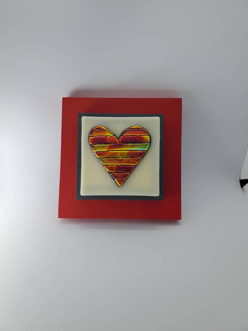 Red Gold colored fused dichroic glass heart on off white glass and red frame wall art by Gary Levin Glass