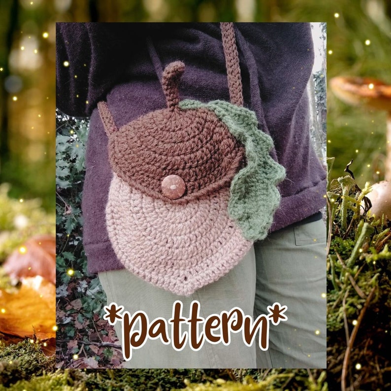 May include: A crocheted acorn-shaped bag with a brown top and a light brown bottom. The bag has a green leaf crocheted on the side and a brown button. The bag is worn as a crossbody bag. *Pattern*