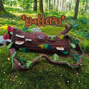 May include: Crocheted log bag with a vine strap, mushrooms, and leaves. The bag is brown with green and brown accents. The text *pattern* is written in orange on the bag.