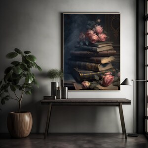 May include: A framed print of a still life featuring a stack of antique books with pink roses on top. The books are arranged on a dark surface with a vintage aesthetic.