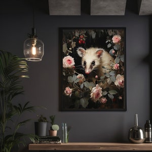 May include: Framed art print featuring a white opossum surrounded by pink roses and greenery. The artwork has a dark, moody aesthetic with a black frame. The opossum's fur is detailed, and the roses are in full bloom, creating a vintage feel.