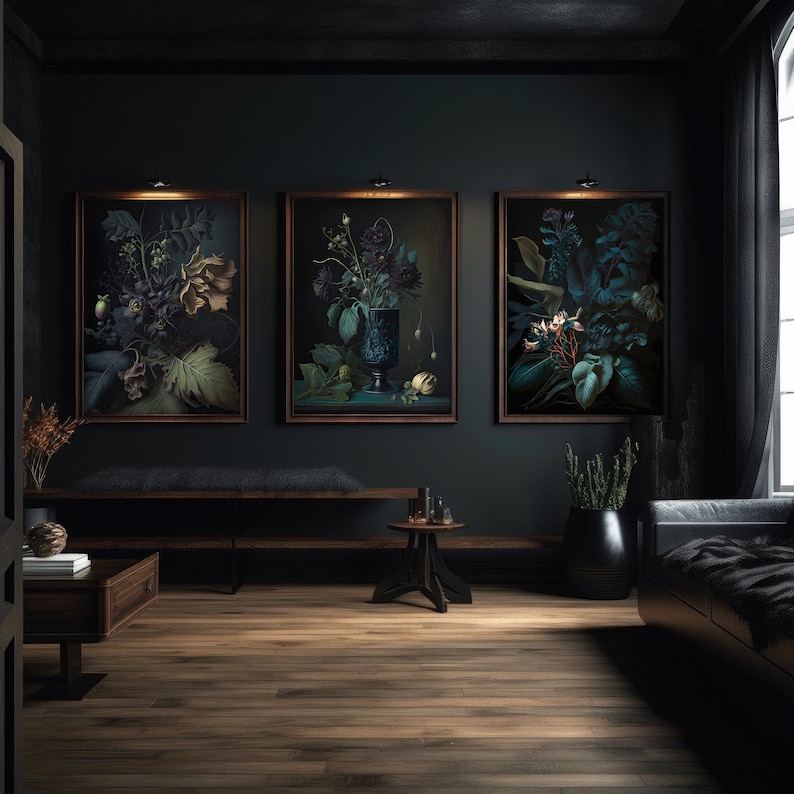 May include: Three framed botanical prints with dark green leaves and flowers in a dark room with a wooden floor, a bench, and a small table.
