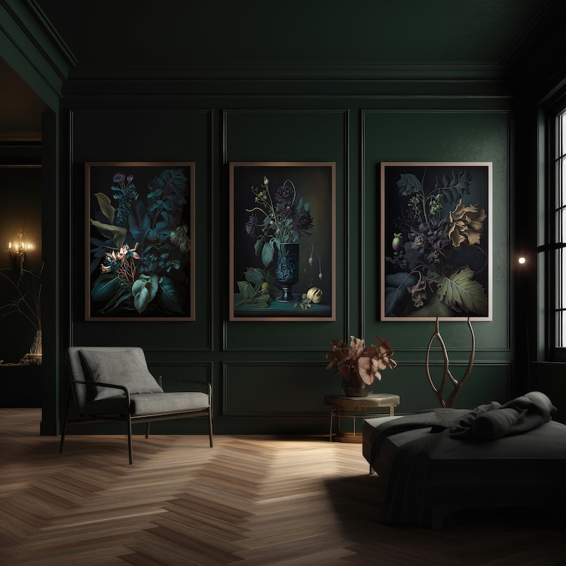 May include: Three framed botanical prints with dark green leaves and flowers in a dark green room with a gray chair and a black couch.