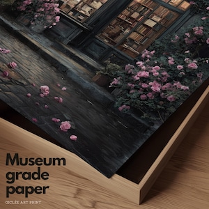 May include: A framed gicl&eacute;e art print featuring a romantic scene of a building facade with a window filled with books and pink roses. The print is labeled "Museum grade paper". The artwork is displayed in a wooden frame.