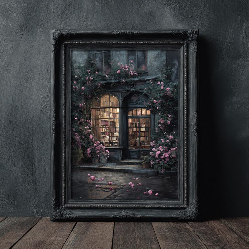 May include: A framed print of a bookstore exterior, with a dark, ornate frame. The image depicts a building with arched windows filled with books, surrounded by climbing roses. The scene is lit with warm interior light and soft exterior lighting.