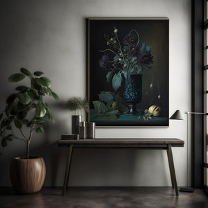 May include: A dark green vase with a floral design holds a bouquet of dark purple flowers against a black background. The vase is on a teal surface with a yellow fruit and green leaves.