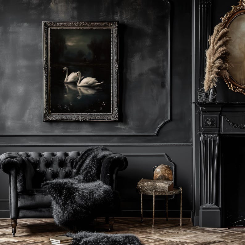 May include: A black framed painting of two white swans swimming in a dark lake, hanging on a dark gray wall in a room with a black leather sofa and a fireplace.
