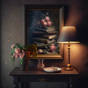 May include: A framed painting of a still life with pink roses and a stack of books. A table lamp with a dark gray shade is lit and sits on a dark wood table with a vase of pink flowers and a clear glass vase.