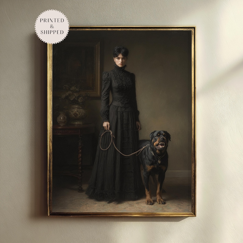 May include: A framed print of a vintage painting featuring a woman in a long black dress holding a leash attached to a Rottweiler dog. The painting has a gold frame and the text "PRINTED & SHIPPED" is in a circle in the upper left corner.