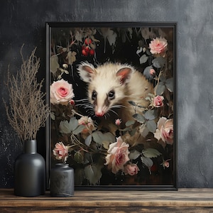 May include: Framed art print featuring a white opossum surrounded by pink roses and foliage. The artwork has a dark, moody aesthetic with a black frame. The opossum has a pink nose and ears, and the roses are in full bloom.